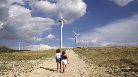 Eolic wind turbines and two children Stock Footage 137441703