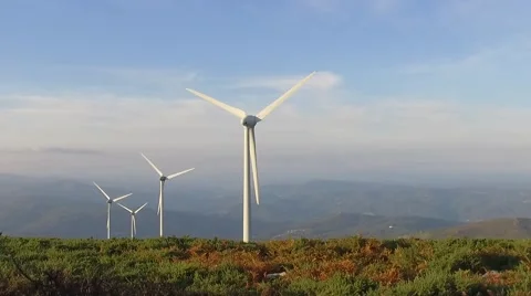 Eolic windmill turbine wind renewable energy farm on top of mountain slowmotion Stock Footage 67859471