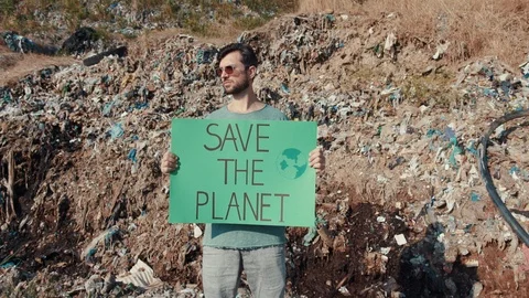 Eological movement. Young smart man with volunteer poster Save the Planet Stock Footage 113819395