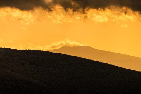 Epc winter mountain landscape with layers of hills under a dramatic dark st.. Stock Photos