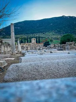 Ephesus Roman Agora Columns Stack in Foreground Against Cypress Hills 스톡 사진