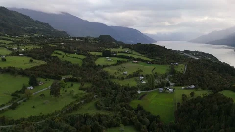 Epic Aerial Arc Flight Over Patagonian Fjord with Majestic Sunbeams Through Clou Stock-Footage 334320859