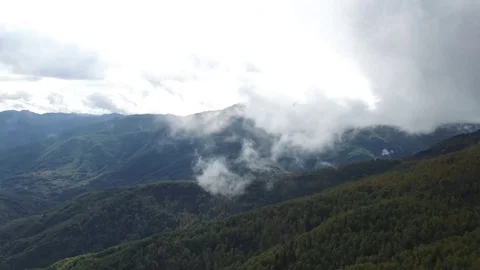 Epic aerial flight over the forest high in the mountains through the clouds Stock Footage 126065096