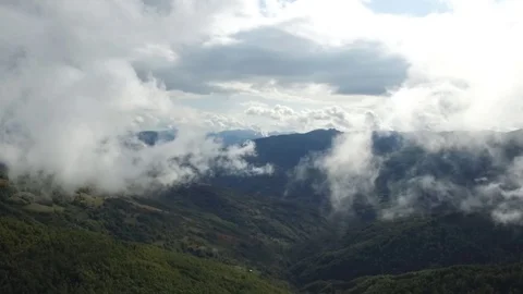 Epic aerial flight over the forest high in the mountains through the clouds Stock Footage 126065256