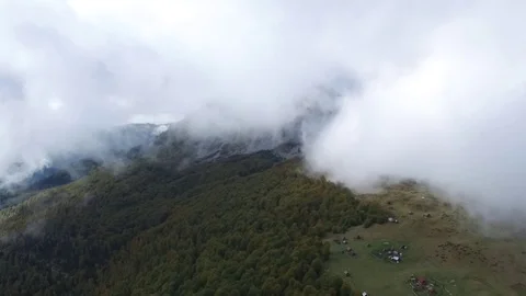 Epic aerial flight over the forest high in the mountains through the clouds Stock Footage 126958261