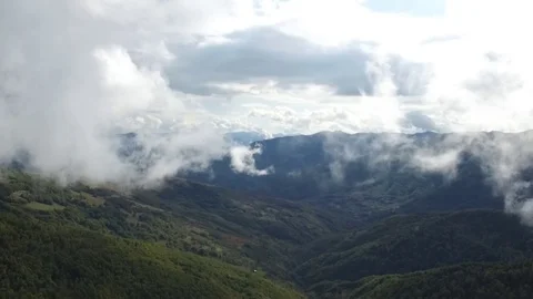 Epic aerial flight over the forest high in the mountains through the clouds Stock Footage 126958292