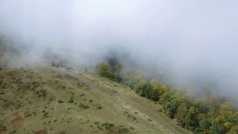 Epic aerial flight over the forest high in the mountains through the clouds Stock Footage 126958355