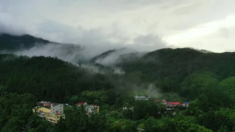 Epic Aerial Flight Through Misty Mountains and Hidden Village ２ Stock Footage 313890144