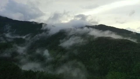 Epic Aerial Flight Through Misty Mountains and Hidden Village 3 Stock Footage 313890282