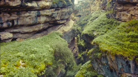 Epic aerial fly down rocky canyon and amazing Avatar style grassy hills in view Stock Footage 69981997