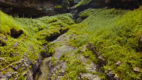 Epic aerial fly down rocky canyon and amazing Avatar style grassy hills in view Stock Footage 69982006