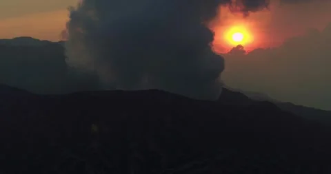 Epic aerial of mountain range with dramatic sunset sky and fog Stock Footage 331712905
