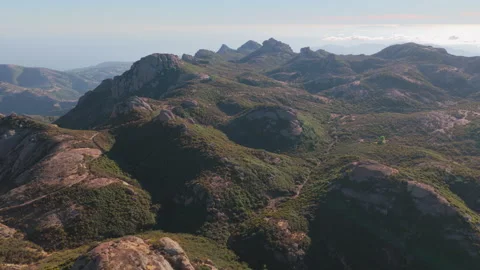 Epic aerial over lush rolling hills near Sandstone Peak in the Santa Monica Stock Footage 345528537