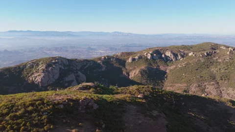 Epic aerial over rolling hills and boulders near Sandstone Peak in the Santa Stock Footage 345528370