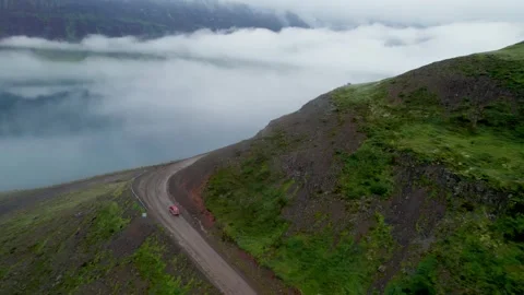 Epic Aerial Red Car Drives West Fjords Iceland Road Through Winding Road Stock Footage 258485033