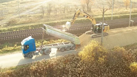 Epic aerial shot of excavator uloading truck with sand. Stock Footage 97798155