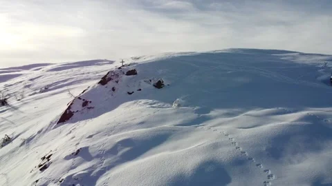 Epic aerial of snow covered mountain with summit cross Stock Footage 145803953