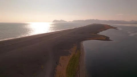Epic Aerial Sunset Over Black Sand Beach Peninsula Ocean and Mountains in Stock Footage 256697339