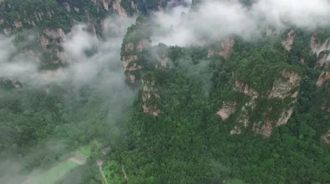 EPIC AERIAL TILT &amp; DOLLY SEQUENCE FLYING INTO FOGGY LAOMOWAN AVATAR MOUNTAINS Stock Footage 65180666