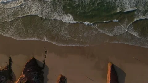 Epic aerial top down view of waves breaking on the shore of a Portuguese beach Stock Footage 170707537