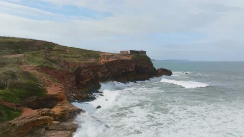 Epic aerial view of big waves of Nazare crashing on rocks with a lighthouse.. Stock Footage 239578130