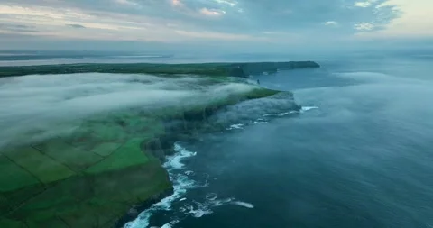 Epic aerial view of Cliffs of Moher above low clouds and Atlantic Ocean, Ireland Stock Footage 339506370