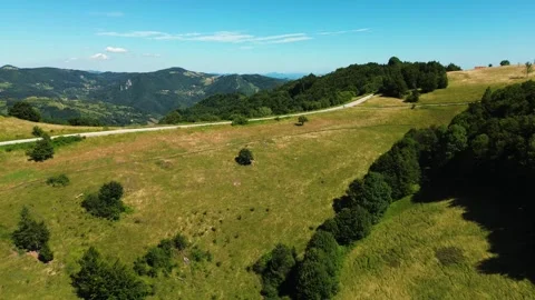 Epic aerial view flying forward ascending over ridge revealing distant peaks Stock Footage 342242373