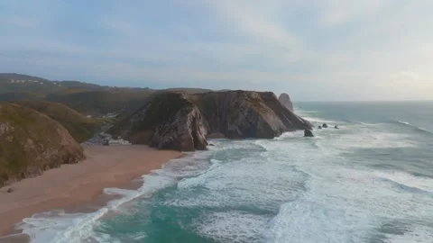 Epic aerial view of large waves crashing in Adraga Beach on a sunny day wit.. Stock Footage 240631936