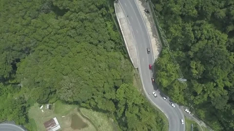 Epic Aerial View of Mountain Highway at Noon in Slow Motion Stock Footage