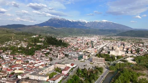 Epic Aerial View Over Berat and River Toward Snow-Capped Mountain Range Stock-Footage 335486579
