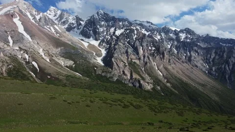 Epic aerial view of rugged alpine ridges and snowy couloirs in Kazakhstan Видео 337126979