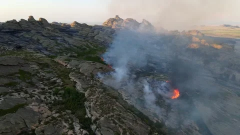 Epic aerial view of smoking wild fire in mountains Stock Footage 155874902