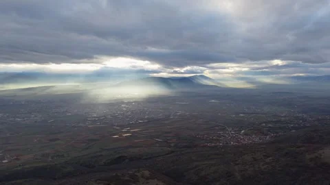 Epic Aerial View of Sun Rays Piercing Through Clouds Over Skopje Valley Stock Footage 336326826