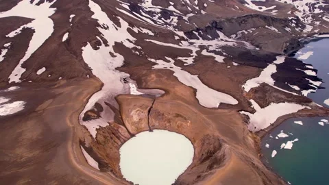 Epic Aerial View of Two Adventure Hikers Walking on Rim of Crater Lake Caldera Stock Footage 256715062