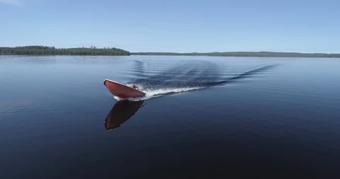Epic and Fast Tracking Shot of a Motor Boat on a Tranquil Lake Video stock 85887122