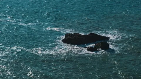 Epic beautiful ocean waves hit huge stone rock sticking out from sea coastline Stock Footage 273794584