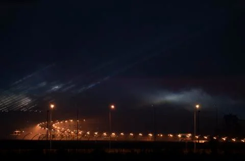 Epic buildings in smoke. Rays of multi-colored searchlights of searchlights. Stock Photos