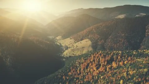 Epic chain hill forest slope sun beam aerial view Fotos Stock