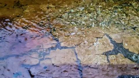 Epic, cinematic close-up of a heavy rain shower on textured concrete Video stock 331252115