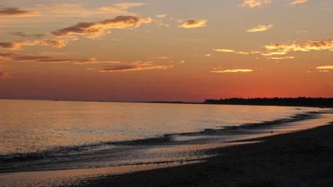 Epic cinematic sunset over calm ocean waves rolling onto beach with sound Stock Footage 166373358