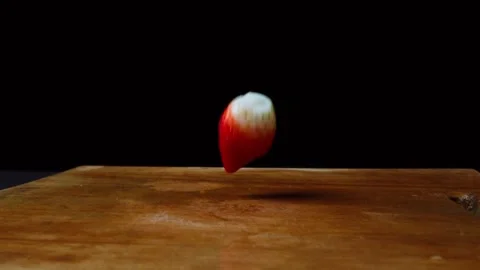 Epic close up of a strawberry falling down in slow motion on a wooden cutting bo Video stock 153205920