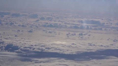 Epic cloud system seen from above through the window of a commercial air plane Stock Footage 82093248
