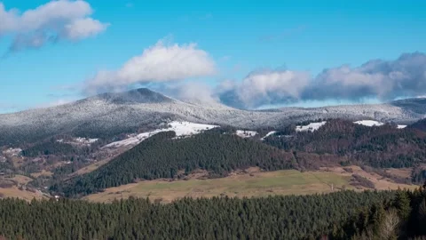 Epic clouds moving over snowy mountains in winter nature landscape Stock Footage 146044771
