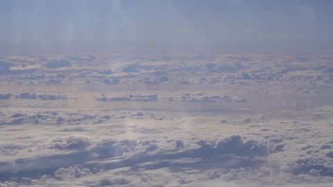 Epic clouds seen from above through the window of a commercial jet aircraft Stock Footage 82093438