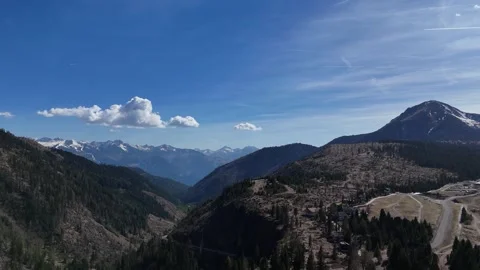 Epic Drone Flight Over Forested Mountainside Revealing Hidden Alpine Vil Video stock 339310803