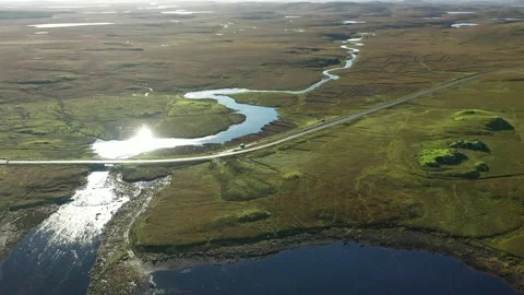 Epic Drone flyover river, hills, sun reflections, Isle of Lewis, Scotland 4K Stock Footage 152914243