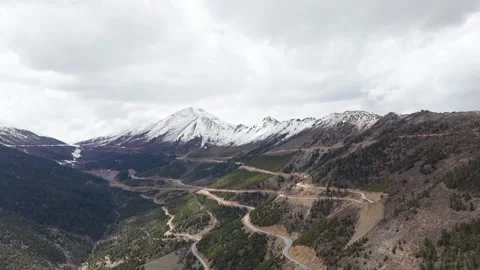 Epic drone footage of a towering snow-covered mountain under a clear sky. Stock Footage 310312178