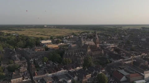 Epic Drone Orbits Historic Cathedral at Golden Hour with Hot Air Balloons Stock Footage 327559872