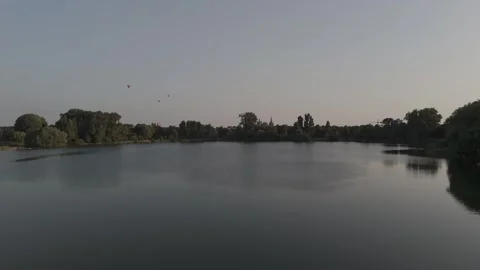Epic Drone Over Lake Approaching Historic Cathedral at Golden Hour Видео 327560089