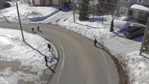 Epic Drone Pullback from Young Kids Playing in Snow Covered Streets to Video stock 139762342